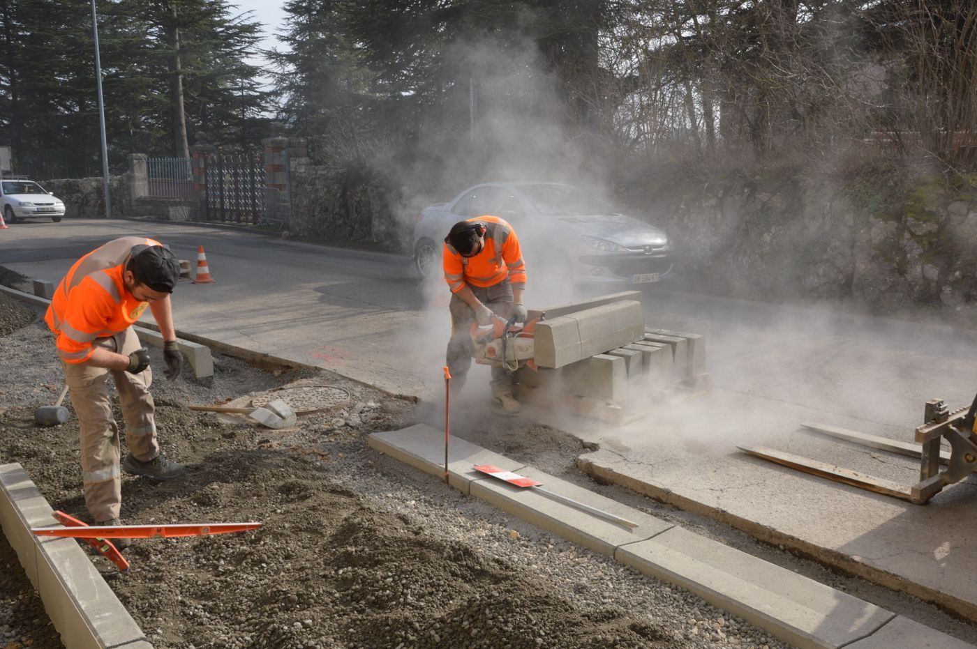 Concrete cutting crew saw-cutting kerbs on a Perth street