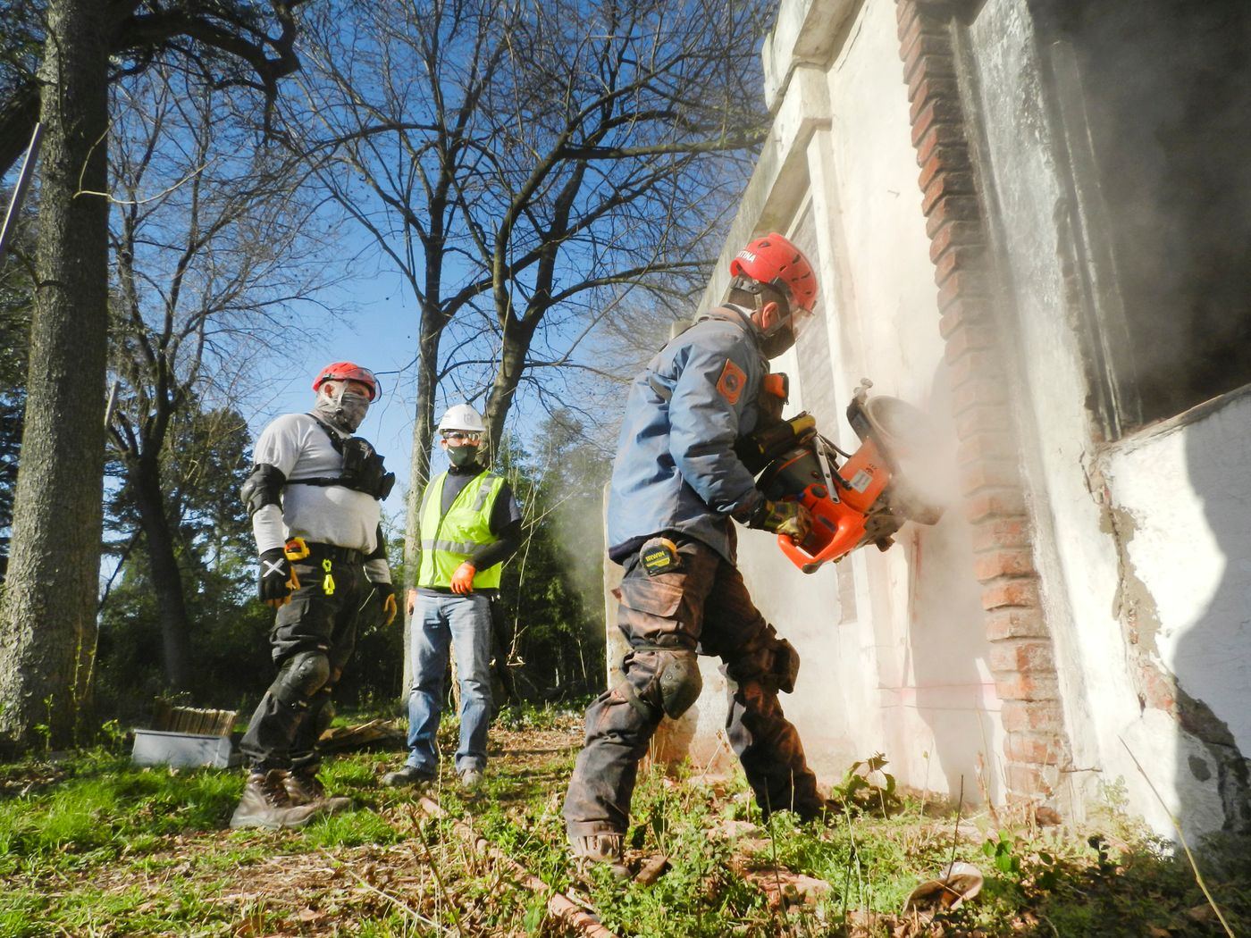 Concrete cutting crew saw-cutting a wall